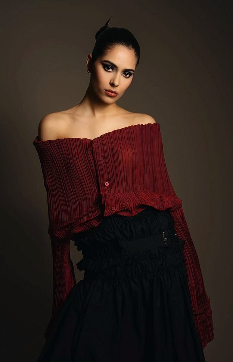 Woman in an off-the-shoulder burgundy blouse and layered black skirt