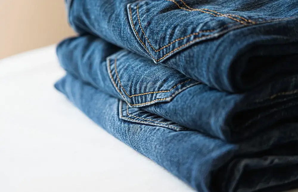 Stack of folded blue denim jeans